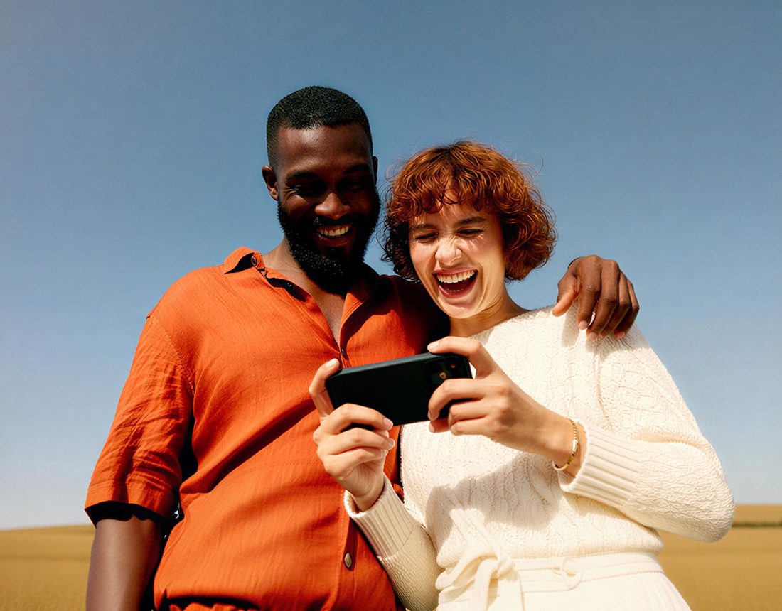 Two people delighted by a message on a phone